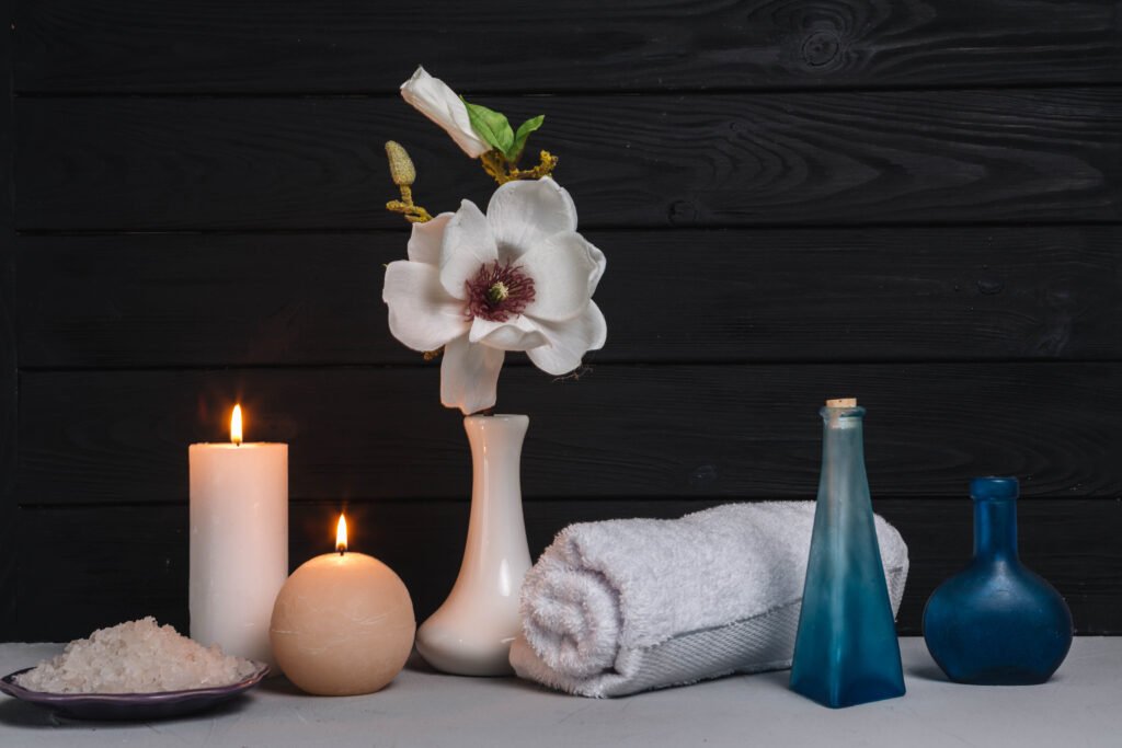 Peaceful spa arrangement with glowing candles, natural elements like leaves and stones, creating a calming and tranquil atmosphere for relaxation